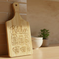 Wooden cutting board with kitchen measurement chart engraving on a dark background